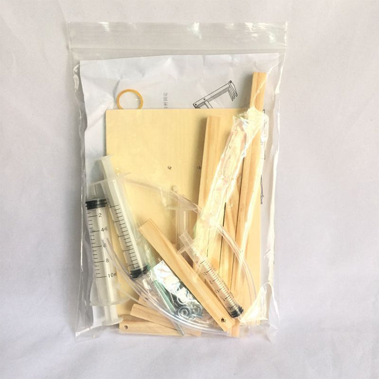 Air excavator DIY kit components packed in a clear bag with wooden parts and syringes