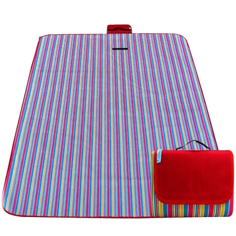 Striped waterproof picnic mat with multicolor lines and red carry pouch