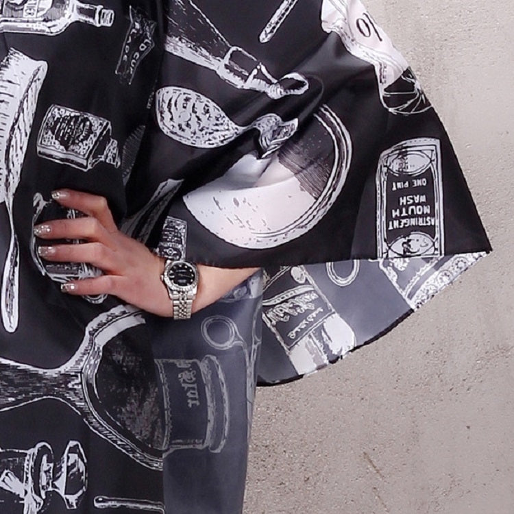 Adult hair-cutting apron sleeve and front panel, black with white tool print
