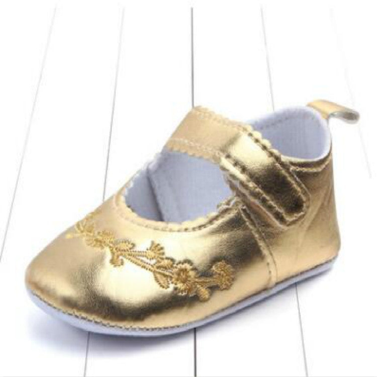 Baby girl first walker crib shoes in gold with hook-and-loop strap and floral embroidery