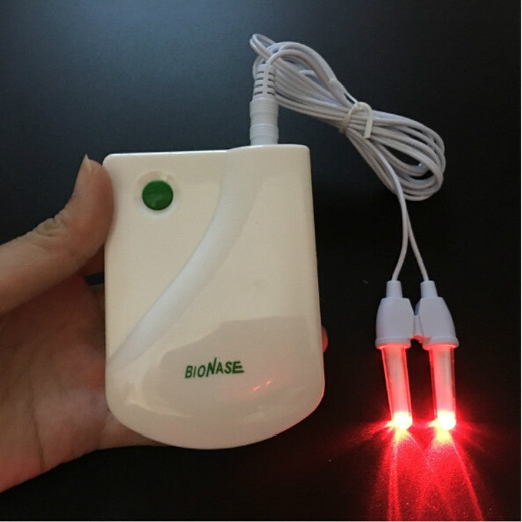 White nasal therapy machine held in hand with two red LED indicator lights