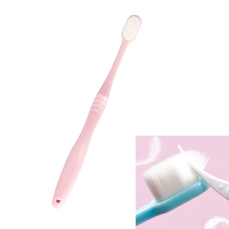 Soft bristle toothbrush with pink handle and rounded brush head