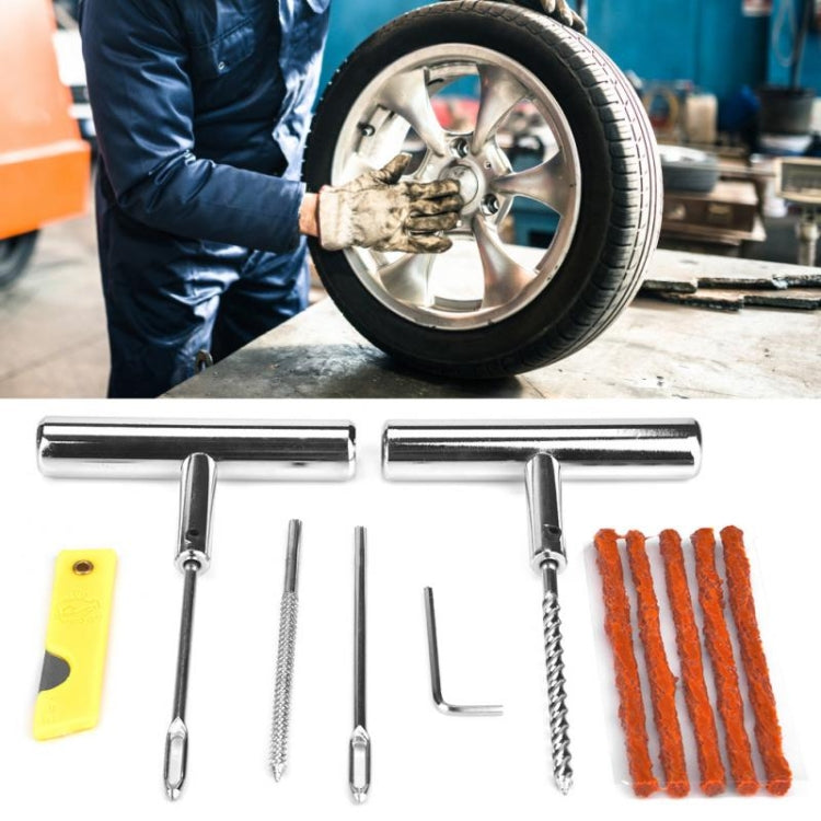 Tire repair kit tools with T-handles and patch strips beside a car tire in service