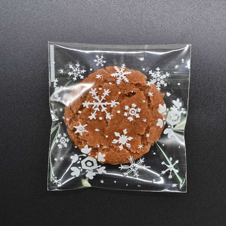 Snowflake cookie snack gift bag: clear pouch with brown cookie design and white snowflake icons