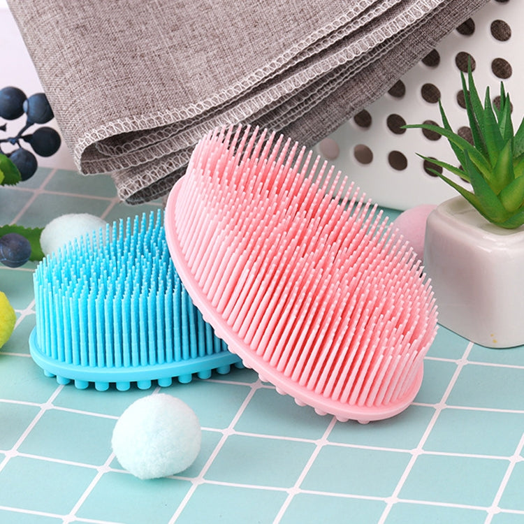 Pink and blue silicone scalp massage brushes with dense soft bristles, set on tile