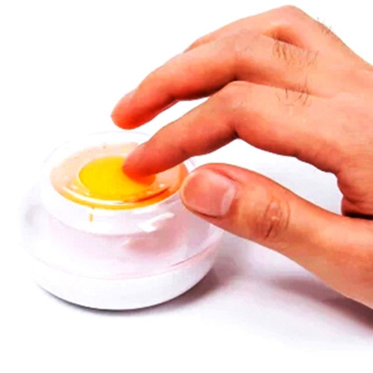 Hand pressing yellow sponge pad on a white cylinder hand-sponge container