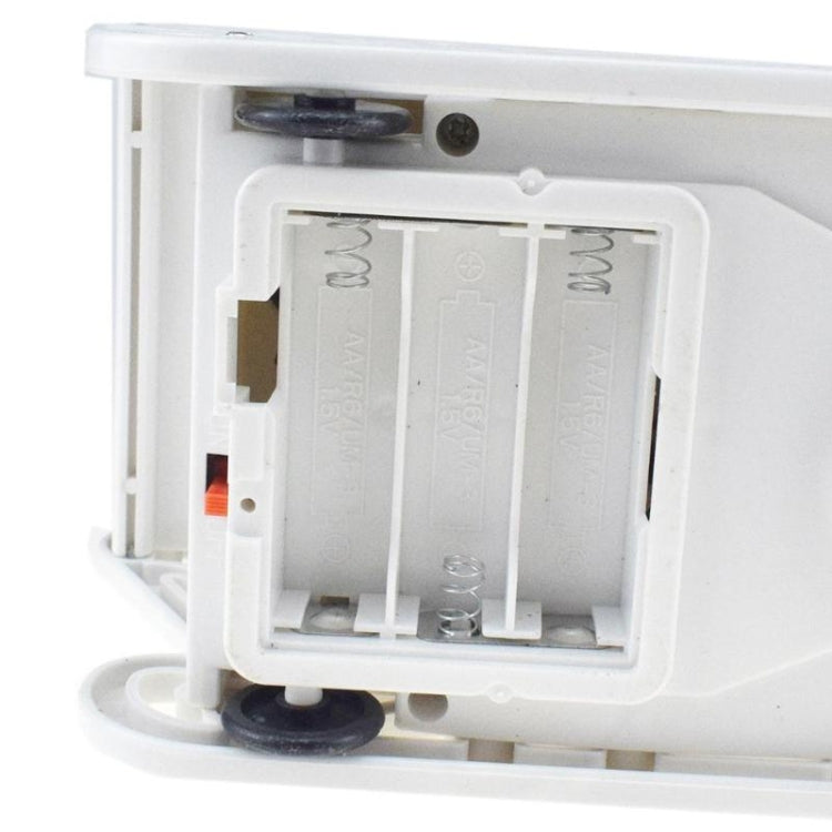 Electric toy battery compartment with screws and metal contacts in white housing