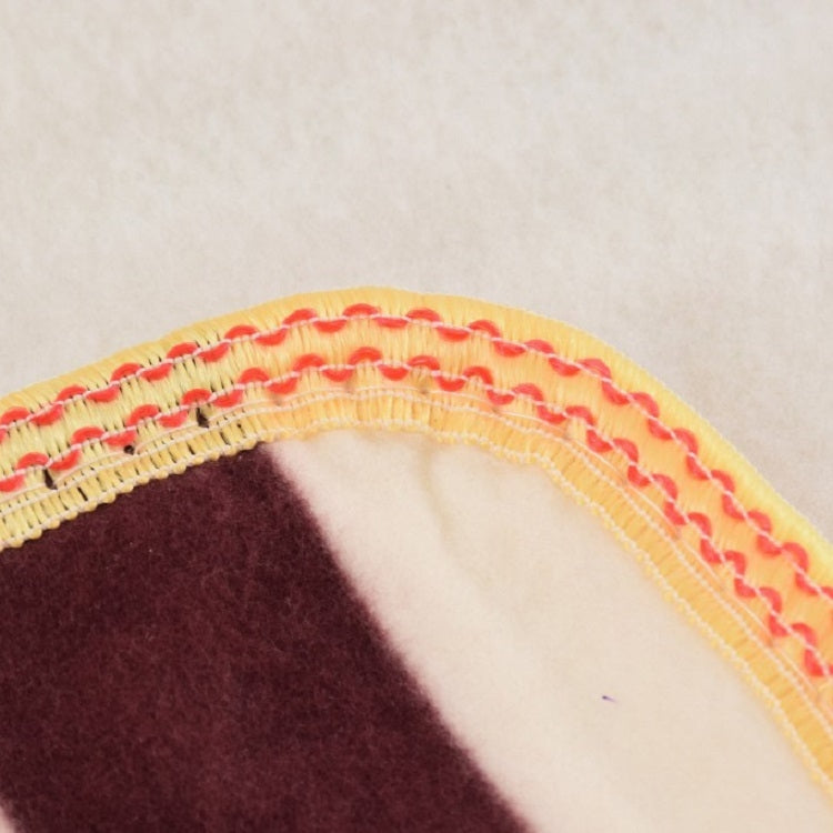 Close-up of plush heating mat edge stitching and trimmed border seam