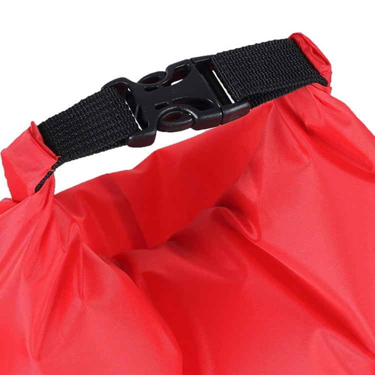 Red waterproof dry bag with black adjustable strap and plastic buckle at top.
