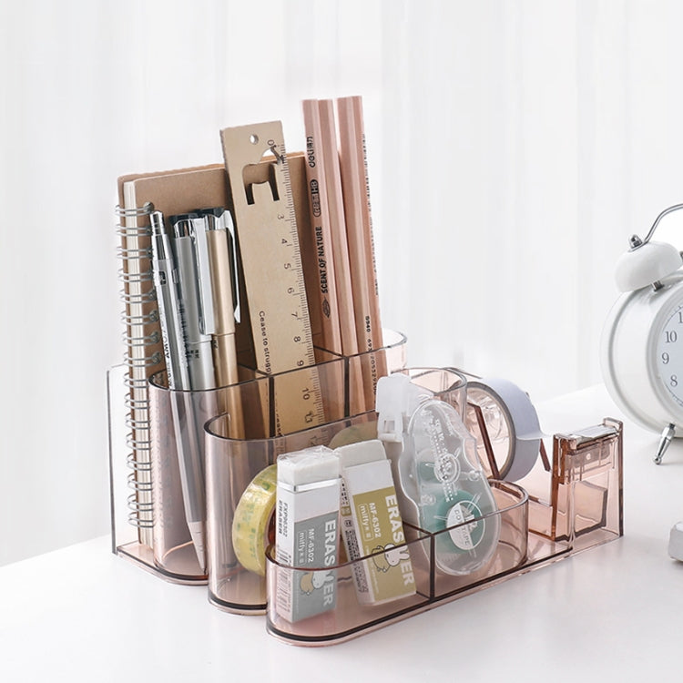 Clear acrylic desk organizer with pen holders, ruler slots, and tape dispenser storage cubby.