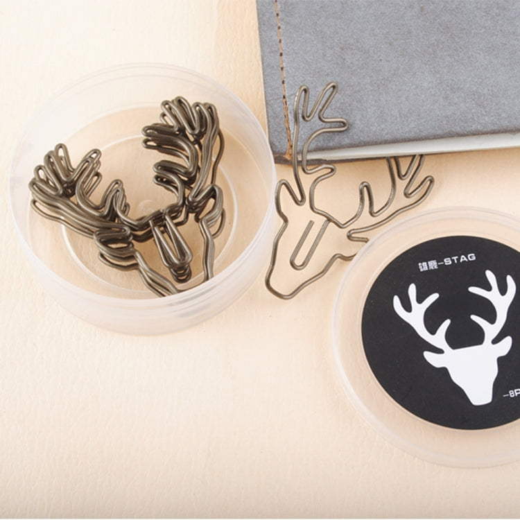 Deer head metal paper clip with antlers on desk near round logo cards