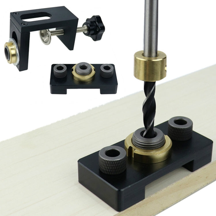 Dowel locator positioned for drilling on a wooden board, black frame with brass drill guide