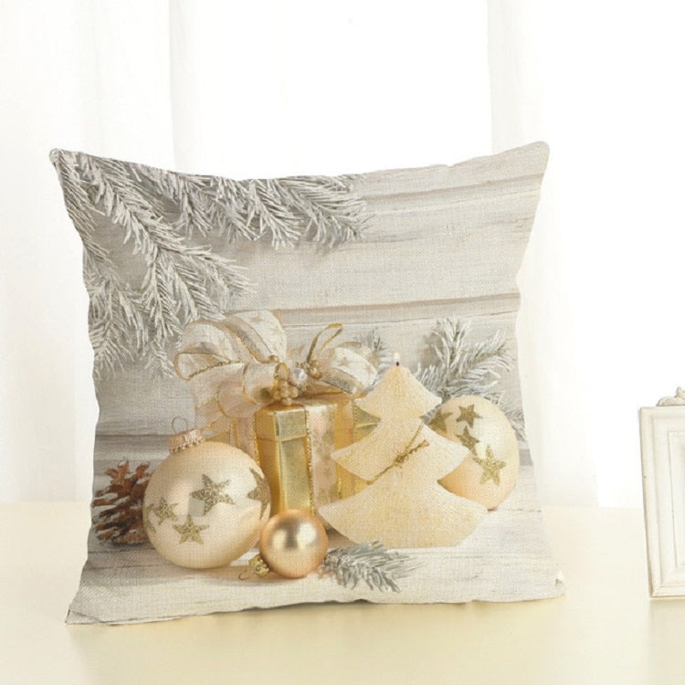 Christmas pillow cover in light gray with gold ornaments, pine branches, and tree-shaped candle