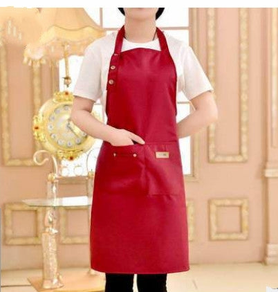 Red canvas apron with bib front, adjustable neck strap, and front pockets