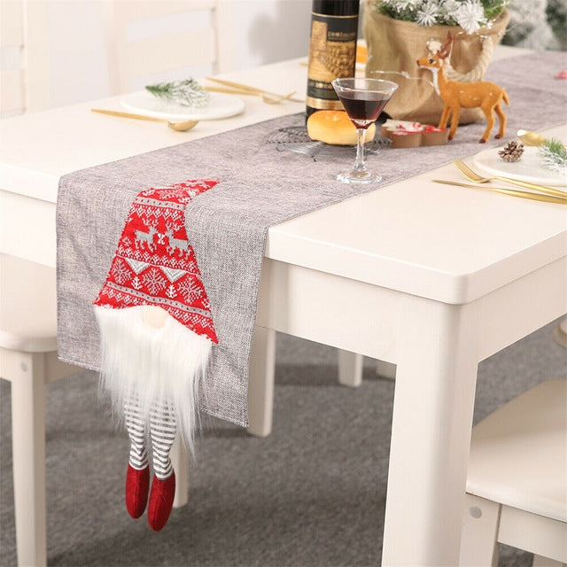 Gray table runner with red Santa hat, white furry beard, and striped legs