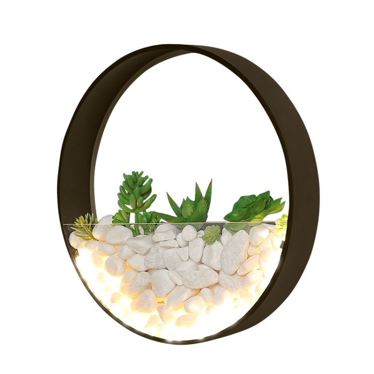 Round wall lamp with dark rim, lit faux succulents and glowing white pebble bed
