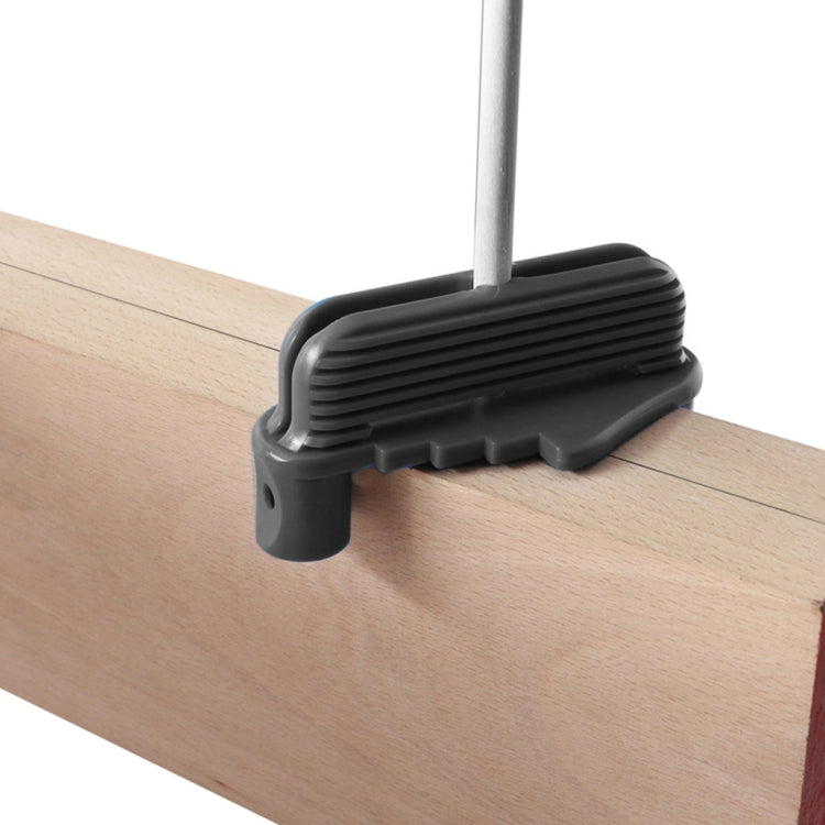 Gray woodworking scriber tool marking line on a wooden board