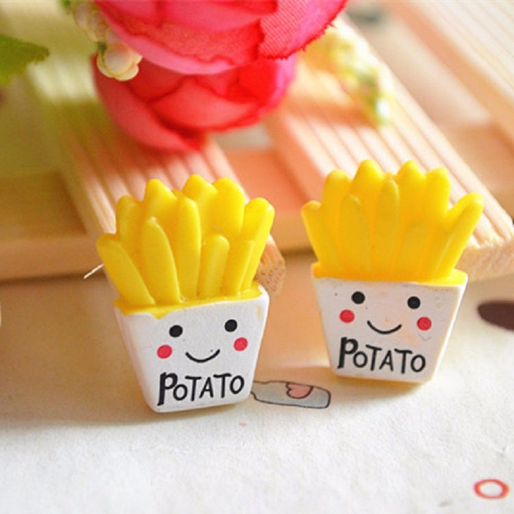 Two French fry resin charms with yellow fries and white “Potato” face print
