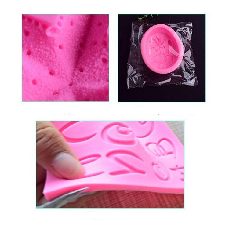 Close-up of pink silicone fondant mold with embossed key, utensil, and heart lock shapes