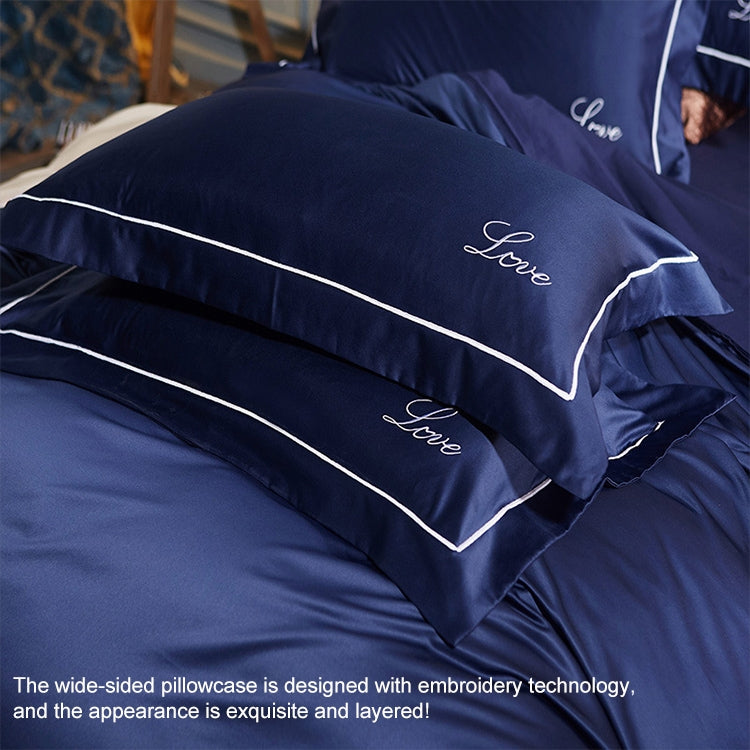 Navy pillowcases with embroidered cursive and double piping trim