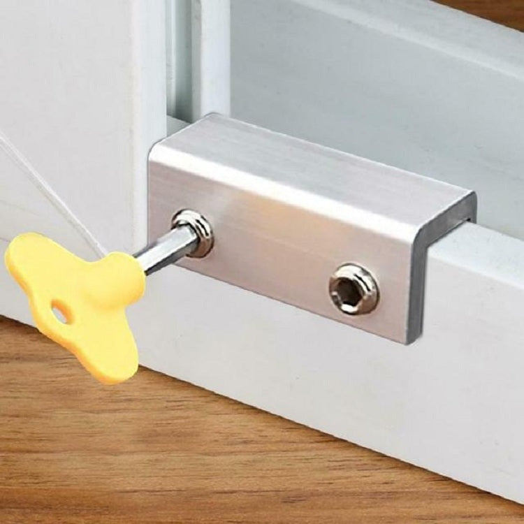 Anti-theft door/window stopper with metal bar and yellow key on window frame