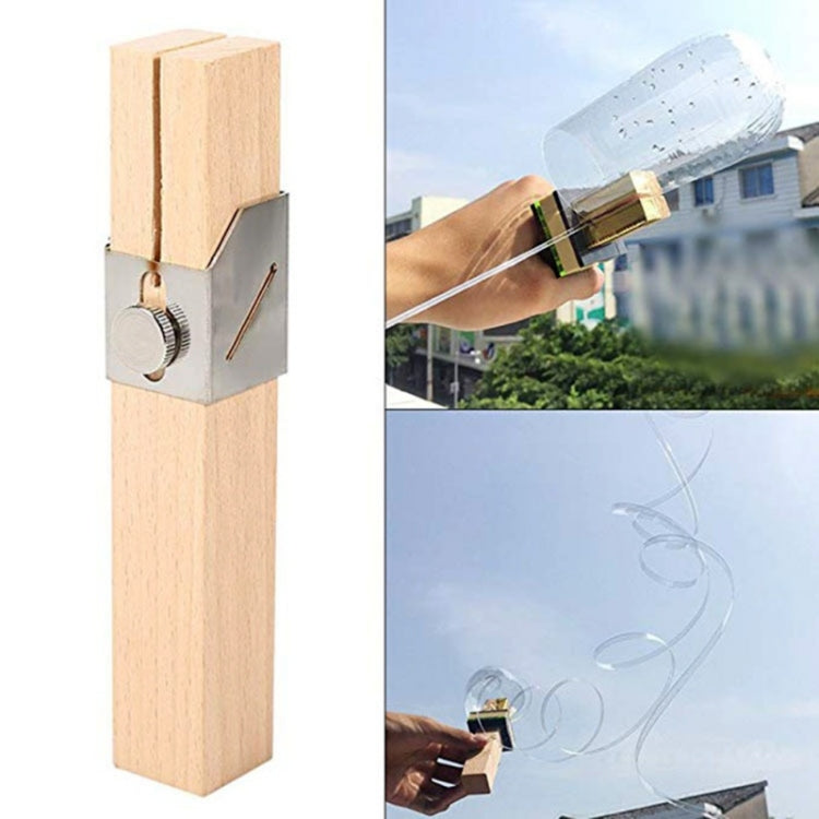 Manual plastic bottle cutter jig on wooden post with metal wheel, shown outdoors
