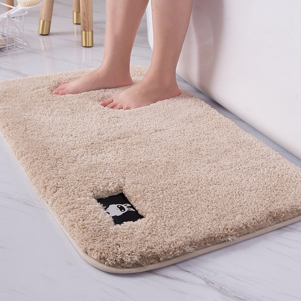 Cream plush bath mat with cartoon patch and textured non-slip backing