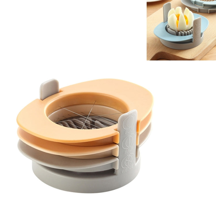 Peach and gray multifunctional egg cutter with slicing grid and half-cut insert