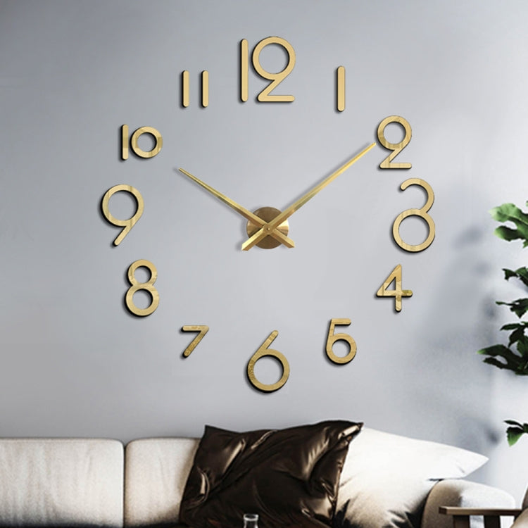 Gold acrylic wall clock with raised 3D numerals and crossed hands