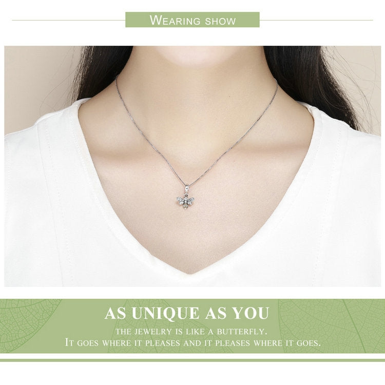 Sterling silver bee charm pendant necklace worn on a V-neck top