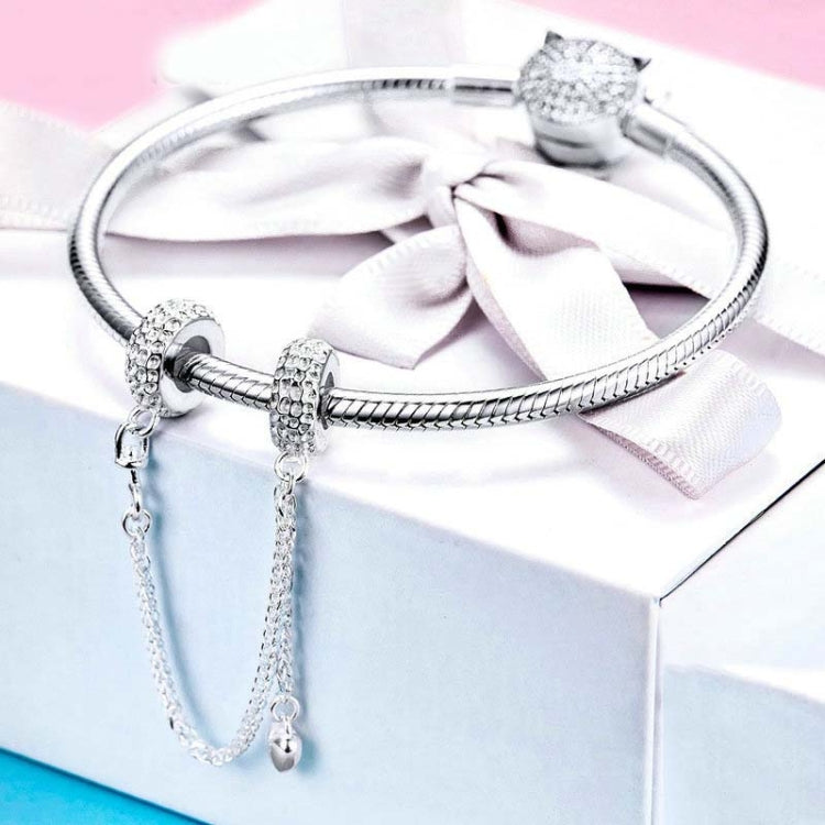 Silver heart charm with safety chain and textured stopper beads on bracelet bangle