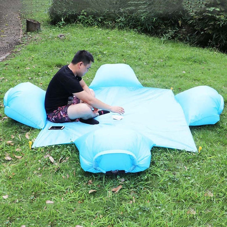 Light blue inflatable air pillow picnic mat shaped for four people, with raised head pillows