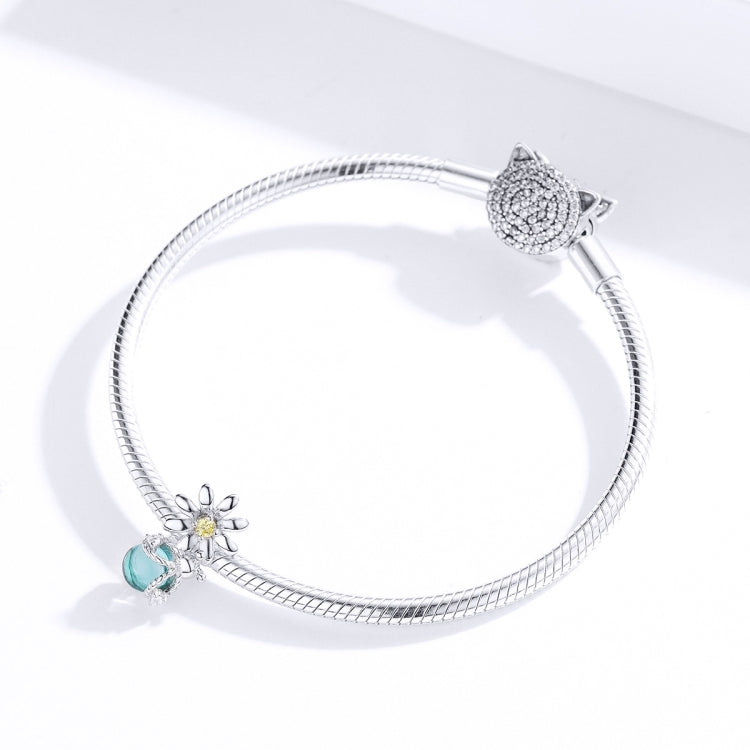 Silver charm bracelet with daisy bead, teal glass drop, and round sparkle end charm