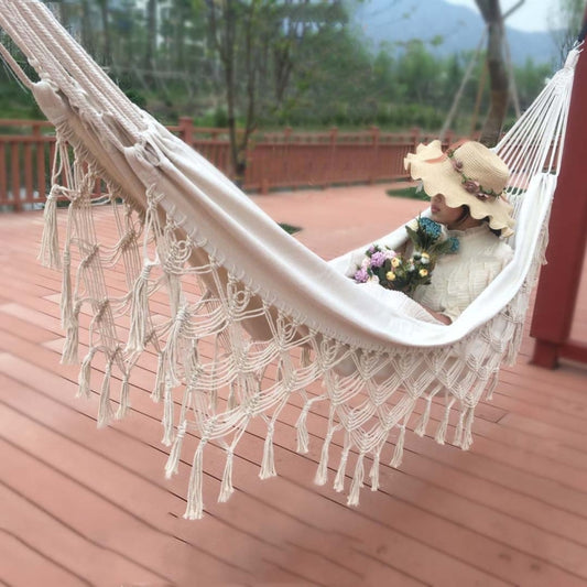 White canvas double hammock with fringe edges and net-style pattern along the bottom