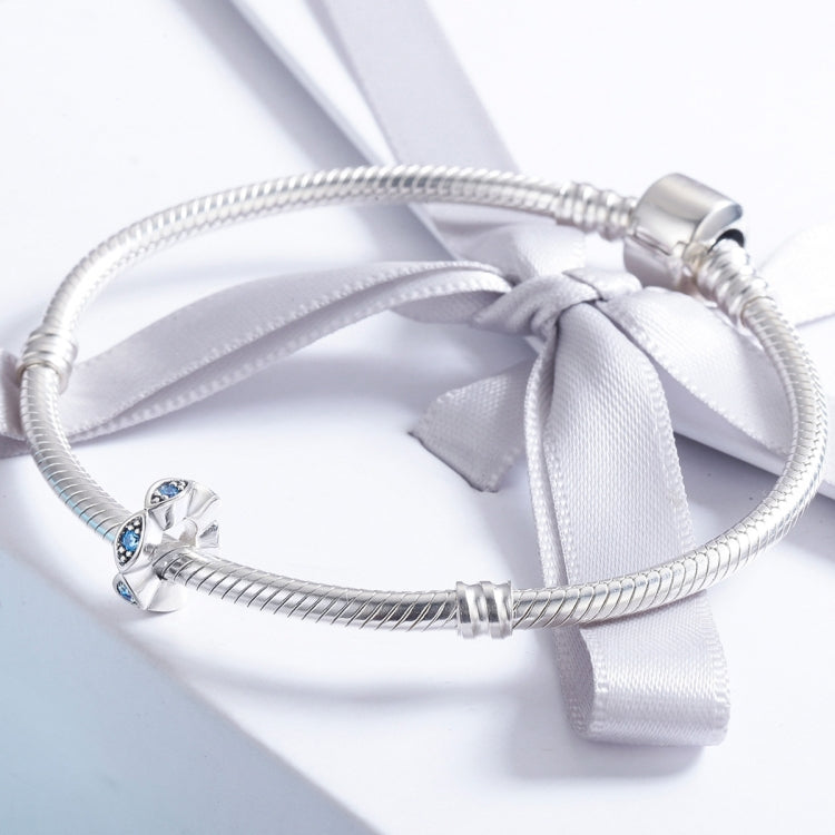 Silver charm beads on snake chain bracelet with blue crystal eye motifs