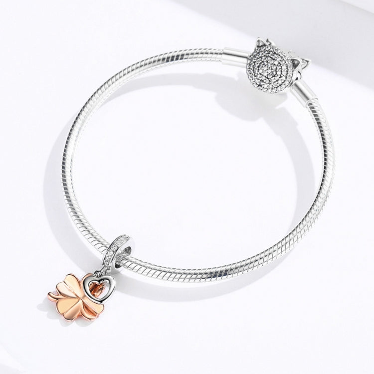 Snake bracelet with clover charm and small heart, plus a cat-head charm on ends