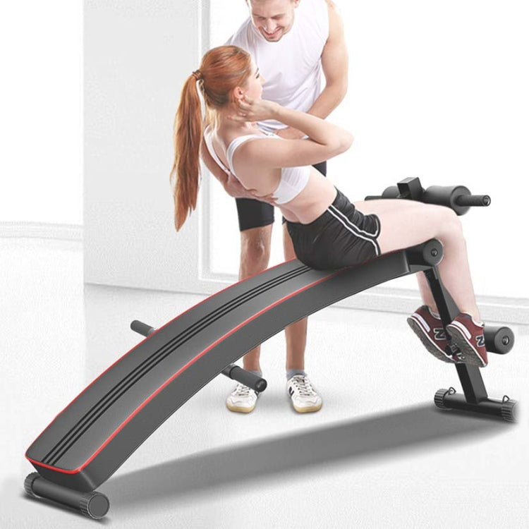 Red and black folding sit-up board with gray feet, foam rollers, and ankle pads