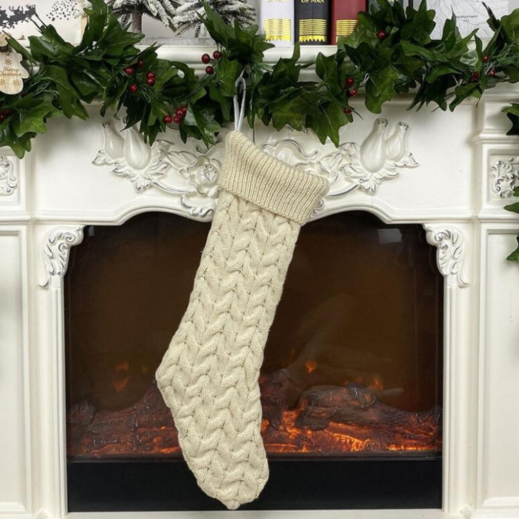 Beige knitted wool Christmas stocking with ribbed cuff and textured cable knit