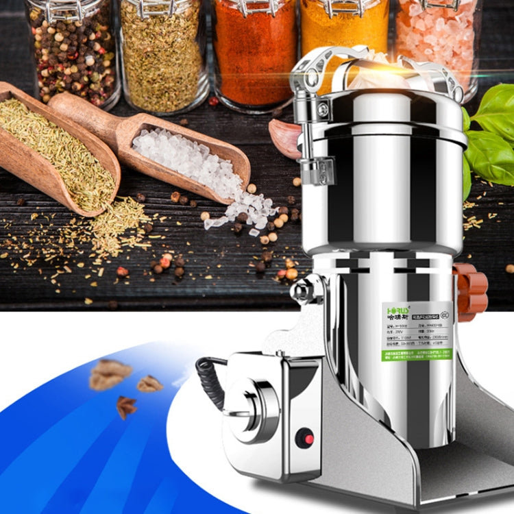 Stainless steel medicinal powder grinder on tabletop with spice jars and measuring tools