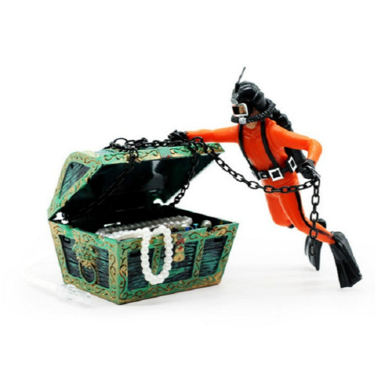 Scuba diver figurine in orange suit with decorated treasure chest and metal chains