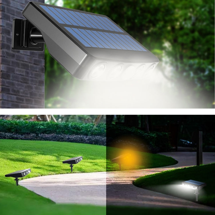 Solar wall light with blue solar panel casting a bright LED beam on outdoor walkway