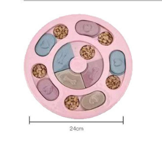 Pink round dog feeding puzzle turntable with treat-filled compartments and central spinner, 24cm