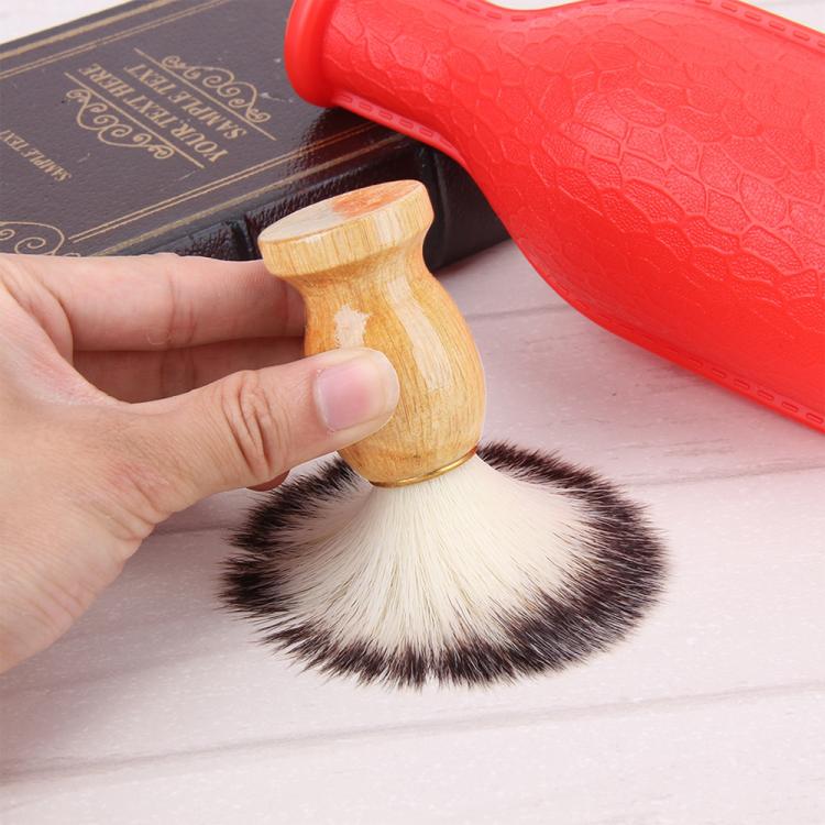 Hand holding wooden shaving brush, dark-and-white bristles and honey handle