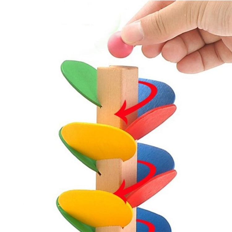 Hand moving wooden tree marble track leaf ramps in green, yellow, blue, and red