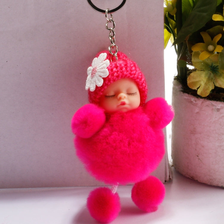 Pink sleeping baby doll ball keychain with white flower knit hat and metal chain ring