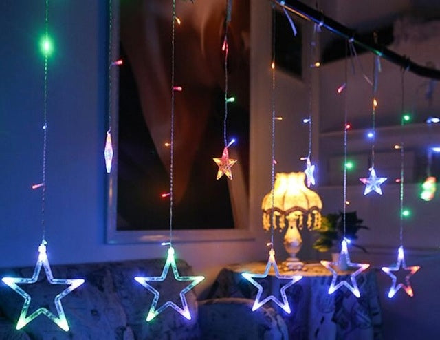 Blue LED star curtain lights with multicolor accents and hanging star pendants on strings