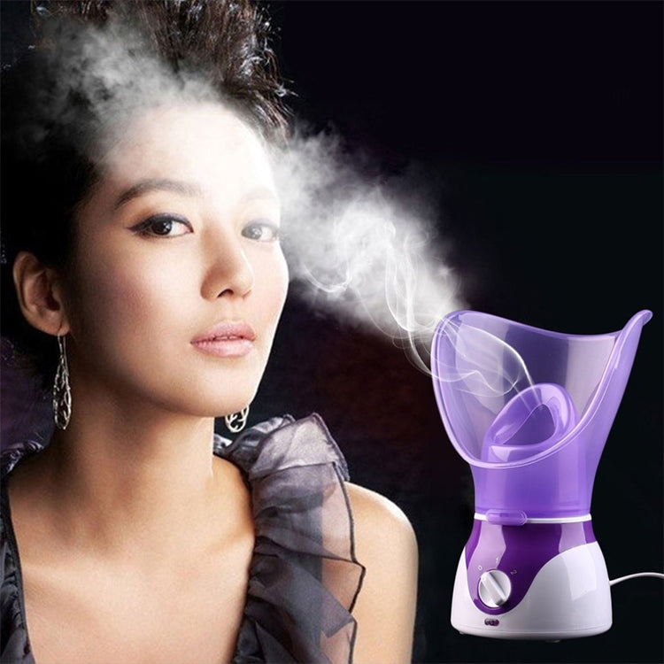 Purple facial steamer producing visible steam, clear hood and front dial on white base.