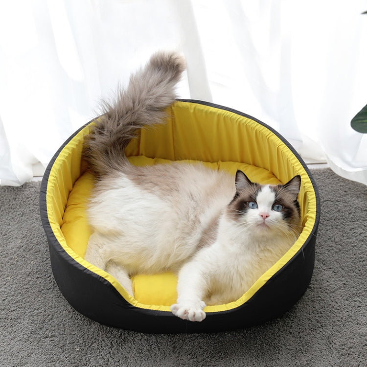 Two-color pet nest with yellow cushion and black outer, cat resting inside