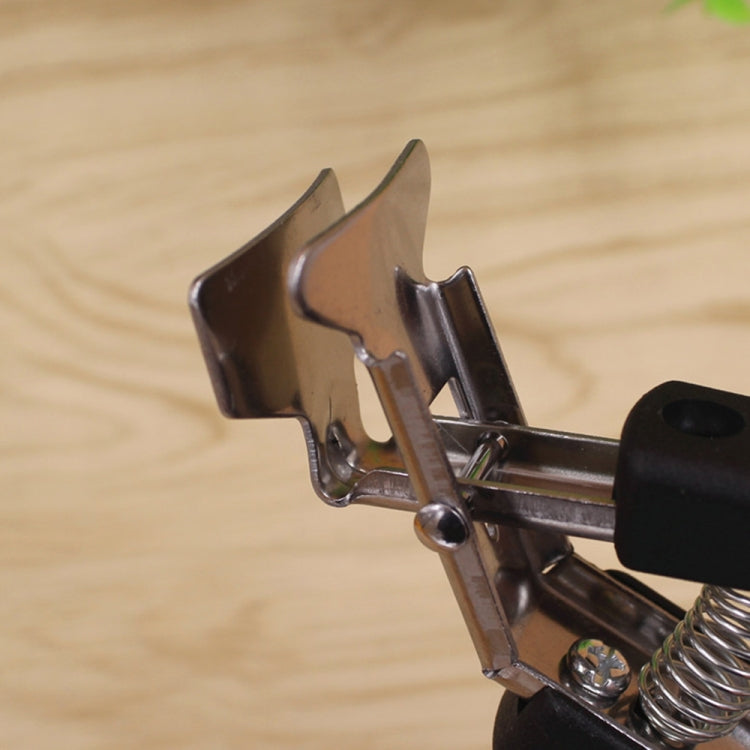 Close-up of black bowl picker clamp jaw and spring grip mechanism
