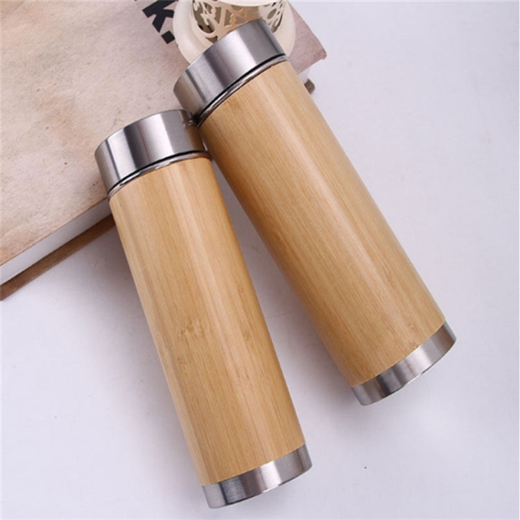 Pair of bamboo vacuum thermos bottles with silver caps and cylindrical lids